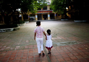 A group of children infected with HIV play together at a local playground in Hanoi on a sunny afternoon.